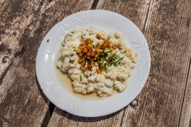 National dish of Slovakia - Bryndzove halusky (potato dough lumps with a sheep cheese and bacon) clipart