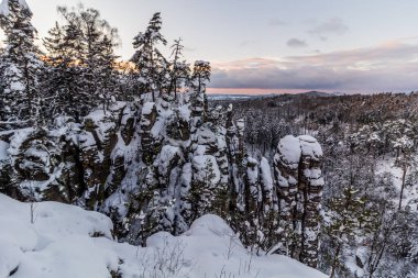 Winter view of snow covered Prachovske skaly rocks in Cesky raj (Czech Paradise) region, Czech Republic clipart