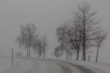 Winter view of I/11 road near Suchy vrch mountain, Czech Republic clipart