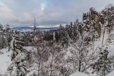 Winter view of snow covered Prachovske skaly rocks in Cesky raj (Czech Paradise) region, Czech Republic clipart