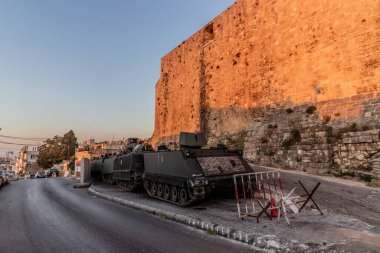 TRIPOLI, LEBANON - JULY 26, 2022: M113 armored personnel carriers in front of the Citadel of Tripoli fortress, Lebanon clipart