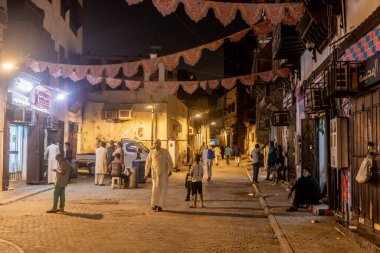 JEDDAH, SAUDI ARABIA - NOVEMBER 15, 2021: Night view of a street in Al Balad,  historic center of Jeddah, Saudi Arabia clipart