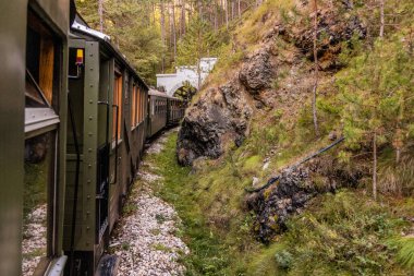 Train entering a tunnel on Sarganska Osmica (Sargan Eight) narrow-gauge heritage railway, Serbia clipart