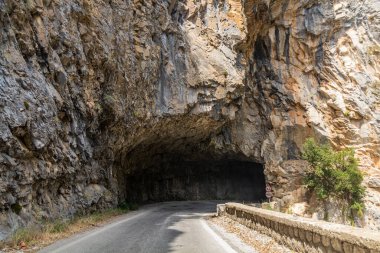 Rock tunnel on Road 82 in Taygetus mountains on Peloponnese peninsula, Greece clipart