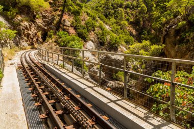 Narrow gauge cogwheel Odontotos railway in Vouraikos Gorge on Peloponnese peninsula, Greece. clipart