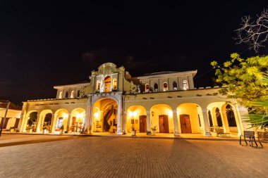 Night view of Plaza de Mercado building in Santa Cruz de Mompox, Colombia clipart