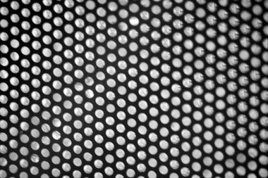 black perforated metal background texture