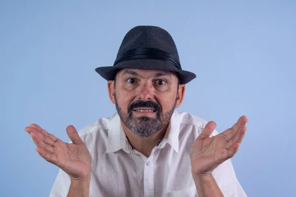 Stock image portrait of elderly man with facial expression and doubt gesture