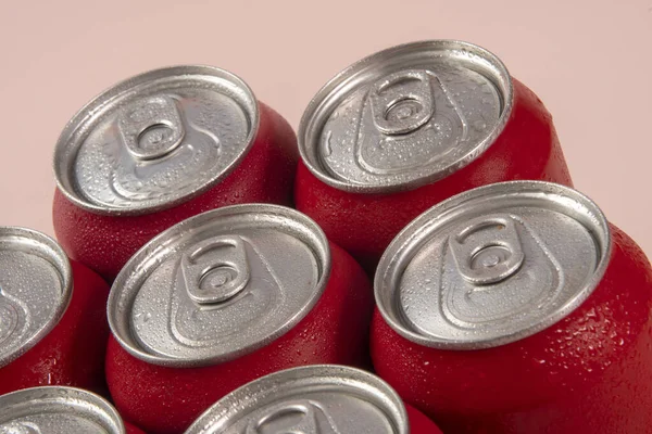 Group of aluminum soda cans, chilled, frozen and with water drops