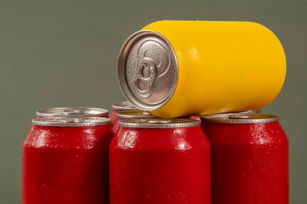 Group of aluminum soda cans, chilled, frozen and with water drops