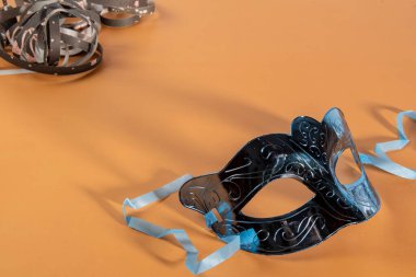 Venetian carnival mask forming frame in one of the lower corners with space for text