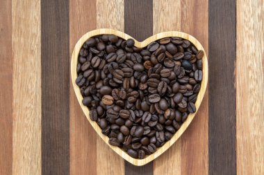 coffee beans in heart-shaped tray representing love of coffee