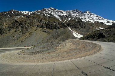 Los Caracoles desert highway, with many curves, in the Andes mountains. Way to Portillo clipart