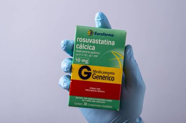 Rio, Brazil - January 27, 2023, hand with protective rubber glove holding medicine box, rosuvastatin calcium