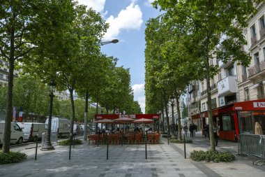 Paris, France, june 06 2024 - avenue champs elysee showing the sidewalk and a cafe clipart