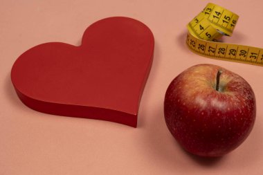 Elma ve mezura ile kalp şekli, kalp sorunu konsepti ve vücut ağırlığı