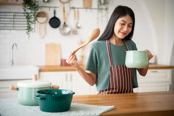 stock image Young beauty asian woman cooking in kitchen room at home