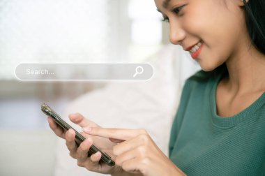 Women use smartphones to find what they are interested in. Searching information data on internet networking concep