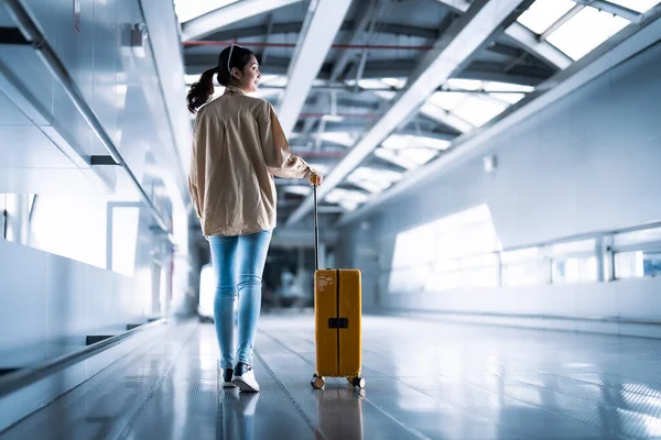 stock image International airport terminal. Asian beautiful woman with luggage and walking in airport