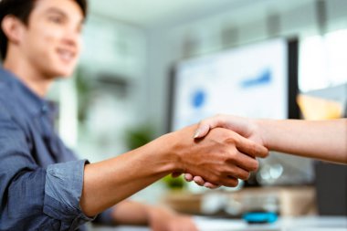 Genç Asyalı iş adamları el sıkışıyor. Modern ofiste ortaklar toplantısı