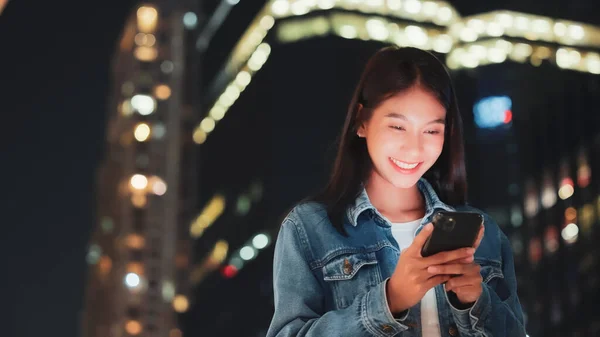 Güzel Genç Asyalı Bir Kadın Cep Telefonuyla Geceleri Şehir Caddesinde — Stok fotoğraf
