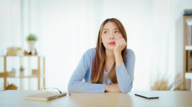 Distracted from work worried young asian woman thinking of problems. Pensive unmotivated lady looking at window, feeling lack of energy