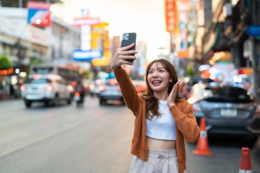 Genç Asyalı turistler selfie çekerek fotoğraf çekiyorlar. Çin Mahallesi 'nde güzel turistler Bangkok, Tayland' da