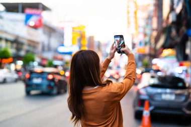 Genç Asyalı turistler selfie çekerek fotoğraf çekiyorlar. Çin Mahallesi 'nde güzel turistler Bangkok, Tayland' da