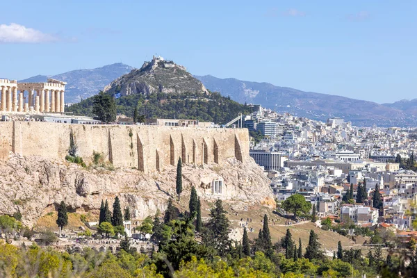 stock image Athens, Greece - October 17, 2022: View of the Acropolis of Athens on a background of blue sky from Muse Hill. Aerial view of the city in the distance and Mount Lycabettus