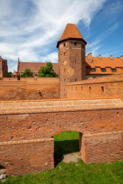 Malbork, Poland - June 25, 2020: 13th century Malbork Castle, medieval Teutonic fortress on the River Nogat. It is the largest castle in the world, UNESCO World Heritage Site