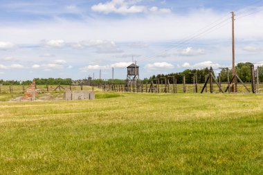 Majdanek; Lublin; Poland - May 25, 2022: Majdanek concentration and extermination camp, view on barbed wire fence and guard tower. It was a Nazi camp built and operated by the SS during the German occupation of Poland in World War II