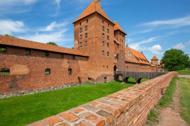 Malbork, Poland - June 25, 2020: 13th century Malbork Castle, medieval Teutonic fortress on the River Nogat. It is the largest castle in the world, UNESCO World Heritage Site