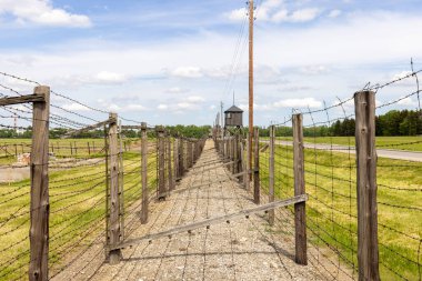 Majdanek; Lublin; Poland - May 25, 2022: Majdanek concentration and extermination camp, view on barbed wire fence and guard tower. It was a Nazi camp built and operated by the SS during the German occupation of Poland in World War II