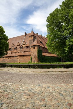 Malbork, Poland - June 25, 2020: 13th century Malbork Castle, medieval Teutonic fortress on the River Nogat. It is the largest castle in the world, UNESCO World Heritage Site