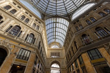 Naples, Italy - June 27, 2021: 19th century Galleria Umberto I renaissance shopping arcade with a steel and glass roof. It is a public shopping gallery