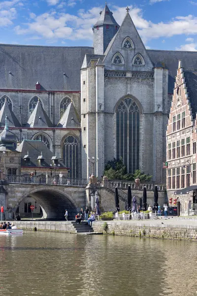 Stock image Ghent, Belgium - May 19, 2023: Saint Michael's Church (Sint-Michielskerk) by Lys river (Leie) and famous arched Saint Michael's Bridge