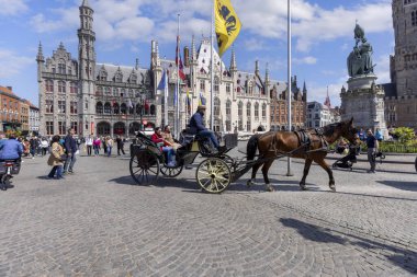 Bruges, Belçika - 19 Mayıs 2023: Ana Meydanda At Arabası (Grote Markt), pazarda gezen misafirlerle birlikte. Arkaplanda tarihi binalar