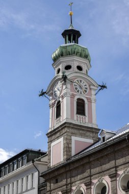 Innsbruck, Avusturya - 26 Şubat 2023: Saat Kulesi ve Maria Theresa Caddesi 'ndeki Kutsal Ruh Hastanesi Kilisesi dekoratif cephesi