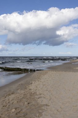Scenic view of the Baltic Sea, rough water and waves, blue sky with white clouds, Wolin Island, Miedzyzdroje, Poland clipart