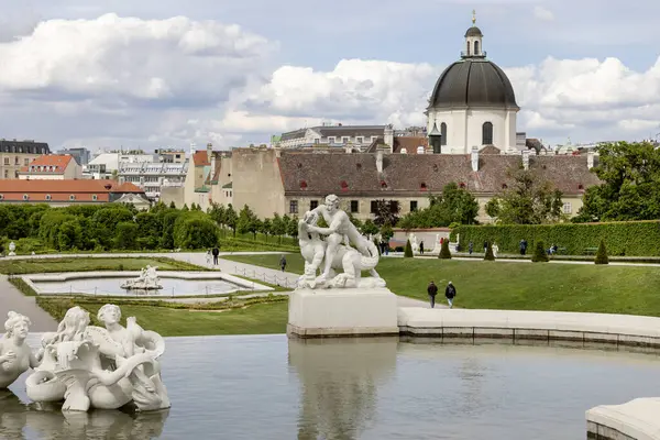 stock image Vienna, Austria - April 25, 2024 : Belvedere Gardens with fountain between Upper and Lower Belvedere palace. Dome of monastery of the Salesian nuns in a distance