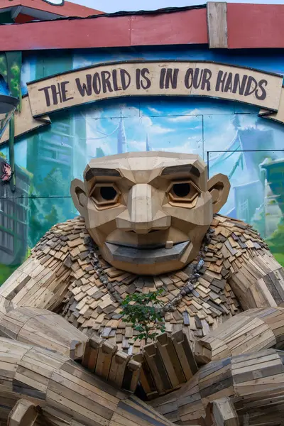 stock image Copenhagen, Denmark - June 22, 2019: Sculpture Green George, Dambo troll, wooden sculpture by Thomas Dambo in Freetown Christiania. Inscription The world is in our hands