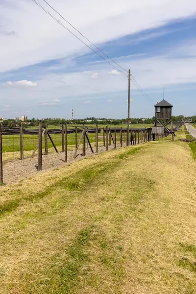 stock image Majdanek; Lublin; Poland - May 24, 2022: Majdanek concentration and extermination camp ( Konzentrationslager Lublin), wooden guard tower and barbed wire fence. It was a Nazi camp built by the SS during the German occupation of Poland in World War II