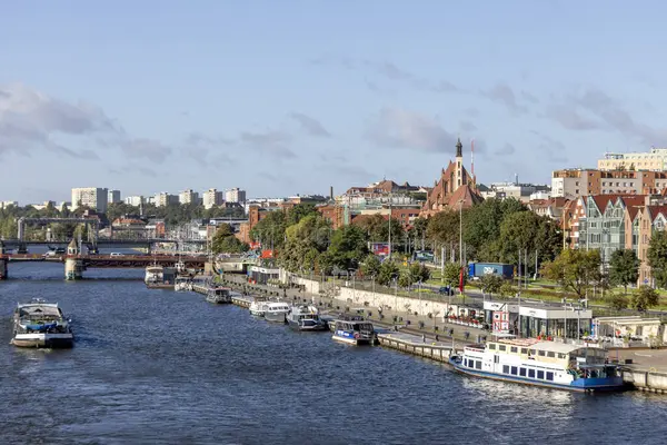 stock image Szczecin, Poland - September 16, 2022: Wieleckie Quay, known as Piastowski Boulevard by Odra River in Old Town, moored tourist ships at the waterfront