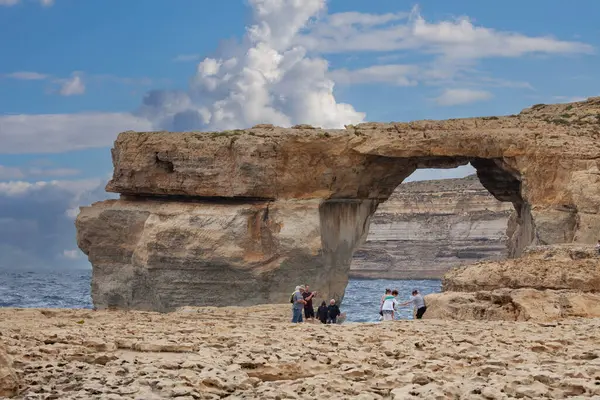 stock image Malta, Gozo - October 22, 2015: Tourists visiting Window Azure, picturesque natural rock arch on coast of island. The arch collapsed completely in 2017.