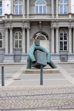 Brno, Czech Republic - March 5, 2023: Statue of Justice on Moravian Square in front of Supreme Administrative Court. Man with hard block who simulates justice is authored by sculptor Marius Kotrba clipart