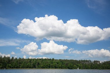 Lake in Polish Masuria with sailing yachts on sunny day. Picturesque cloudy sky, beauty of nature, Masurian Lake Land, Poland clipart