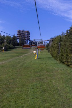 View of chairlift to the mountain with observation tower located at the top of the Slotwiny Arena ski station, Krynica Zdroj, Beskid Mountains, Slotwiny, Poland.