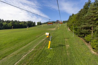 View of chairlift to the mountain with observation tower located at the top of the Slotwiny Arena ski station, Krynica Zdroj, Beskid Mountains, Slotwiny, Poland.