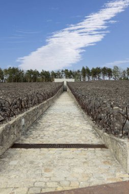 Belzec, Polonya - 29 Nisan 2025: Belzec Müzesi ve Anıtı, Nazi Alman imha kampı. Ölüm Yolu 'nun (Crevasse) görüntüsü, demir tellerle çevrili sembolik kömür yığınından mozoleye doğru
