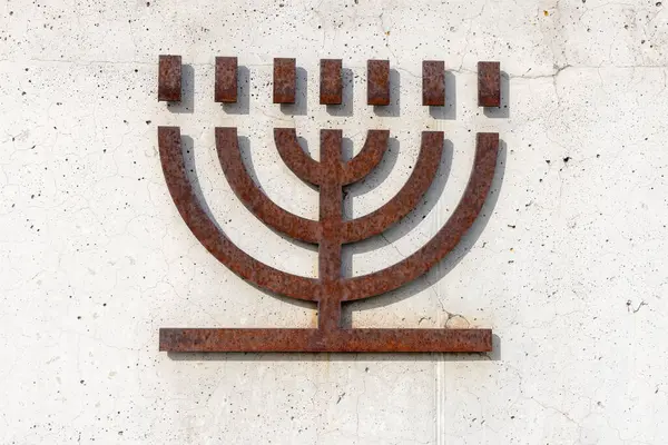 Belzec, Polonya - 29 Nisan 2025: Nazi Alman imha kampı Belzec 'teki Müze ve Anıt' ın girişindeki beton duvara demir Yahudi şamdanı dökün